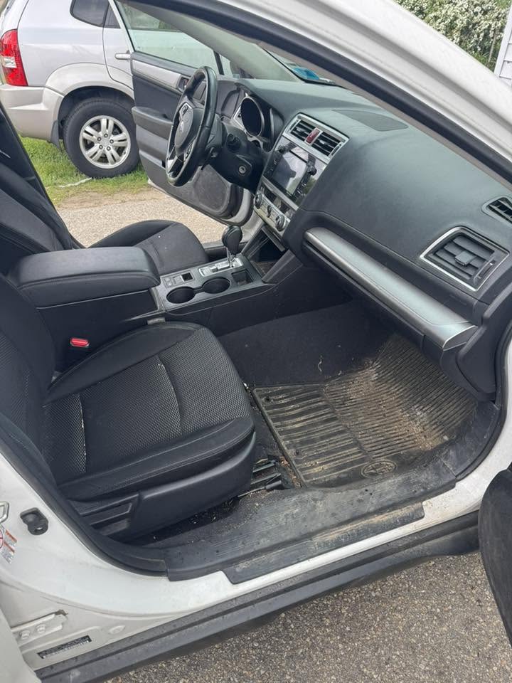 Subaru interior before detail — dirty floor mats and worn surfaces